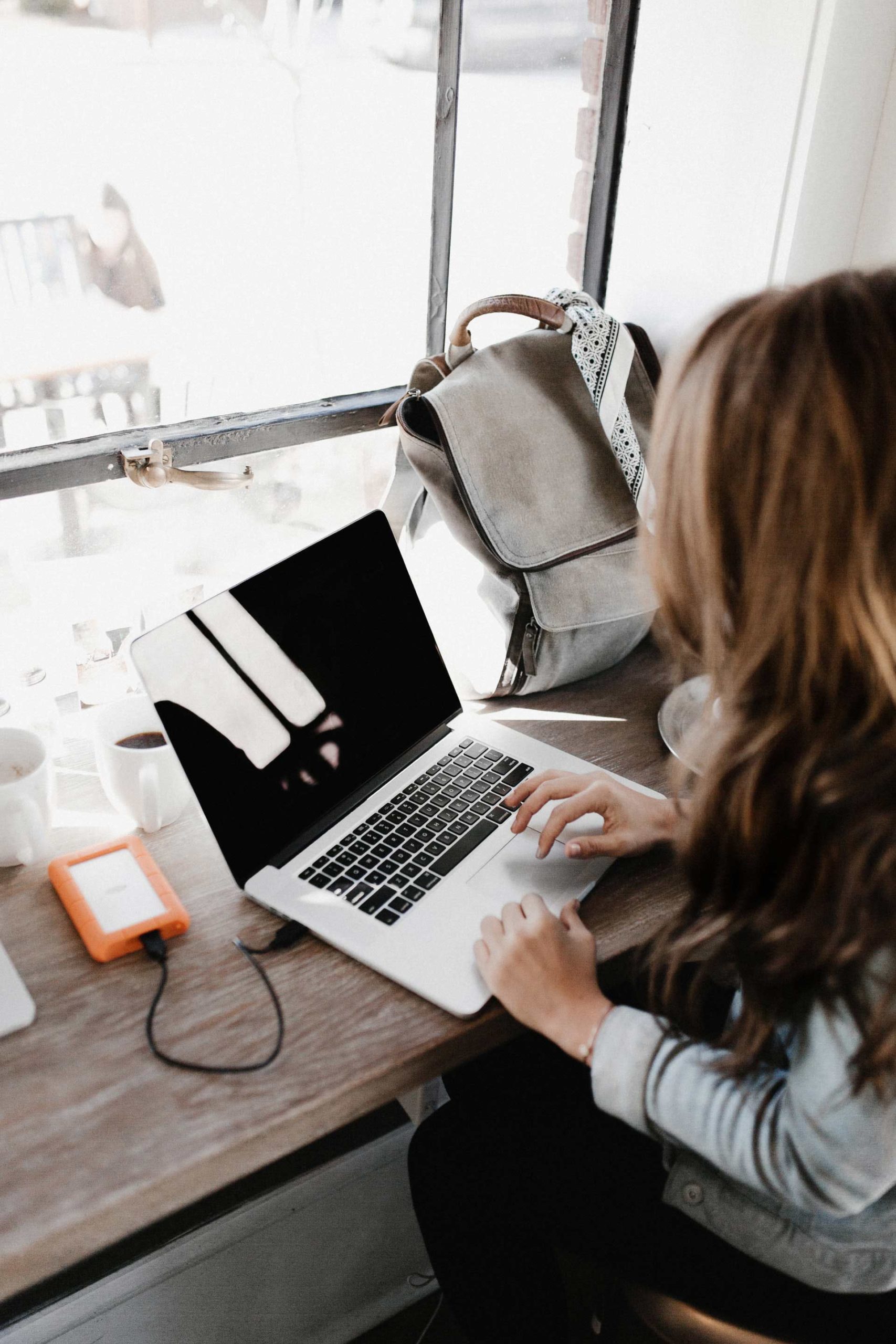 Close Up Photography Of Woman Sitting Beside Table While 3178818